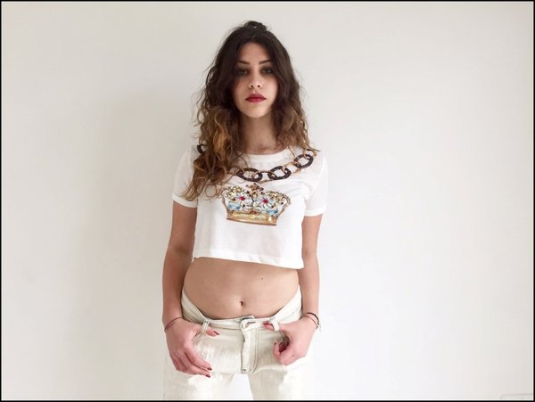  Mini t-shirt corona con mini bag fiori applicati e jeans strappi in paillettes beige.